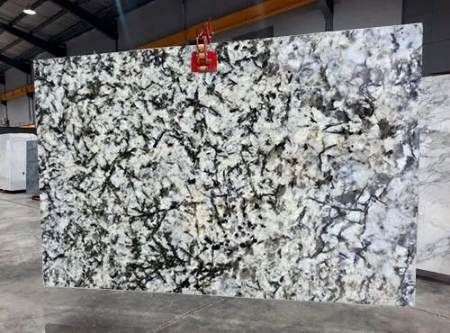 Alaska White White granite slab with black veining pattern in stone warehouse display ALASKA WHITE