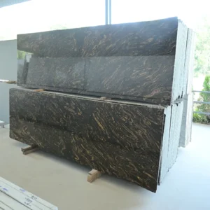 Forest Gold Granite slabs with flowing gold patterns at GL Stone Expo
