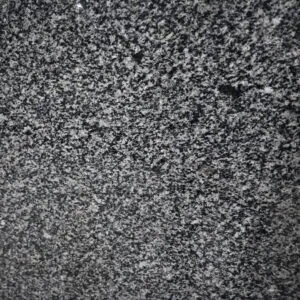 Close-up texture of Chiku Grey Granite polished surface with natural mineral pattern