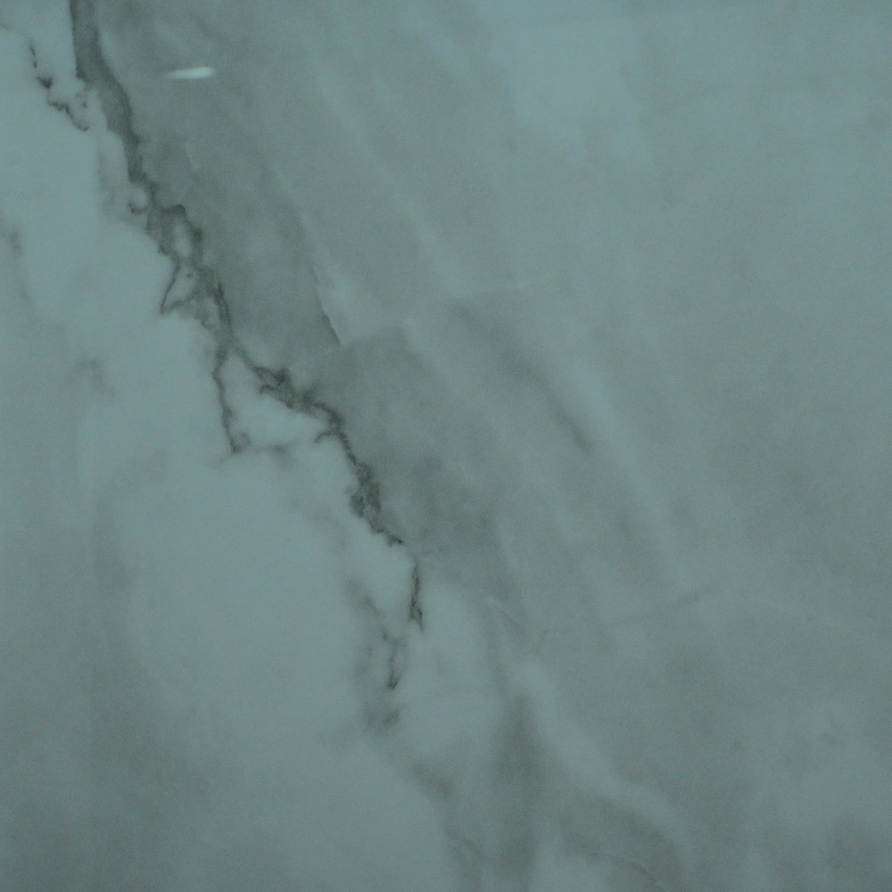 Nuvola Grey Tile featuring a grey-white marble-effect surface with distinctive dark grey veining