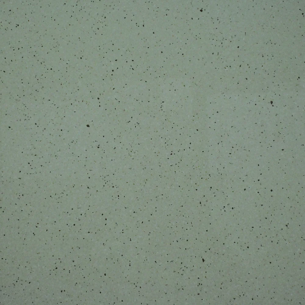 Stella Crema Tile featuring a light cream surface with fine black speckles