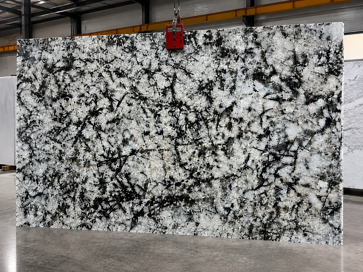 Alaska White granite slab with white and black natural patterns at GL Stone Expo